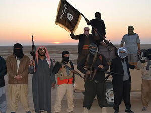Daesh militants pose with their weapons at sunset. (AFP/File)