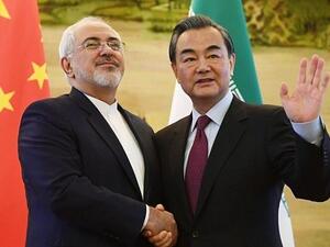 Iran's Foreign Minister Mohammad Javad Zarif (L) shakes hands with his Chinese counterpart Wang Yi. (AFP/ File)