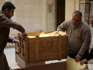 Damascus Museum employees wrap archaeological artifacts into boxes to protect them from being damaged on March 24, 2015, in the Syrian capital (AFP PHOTO / JOSEPH EID)
