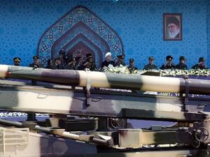 A missile is paraded in front of Iran's President Hassan Rouhani last month (AFP)