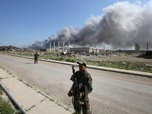 Fighters for the Popular Mobilization units in Iraq patrol a street where an attack was carried out by Daesh on February 29, 2016. (AFP/Ahmad Al-Rubaye)