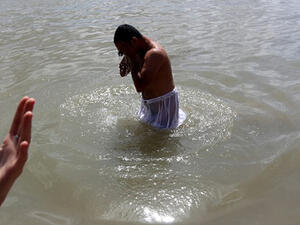 Iraqis Sabeans, followers of a pre-Christian religion which considers the prophet Abraham as one of the founders of their faith, stands in the water as he prays to mark Eid Al-Khalqeh (creation of the world) on the banks of the Tigris River in Baghdad. (AFP/File)