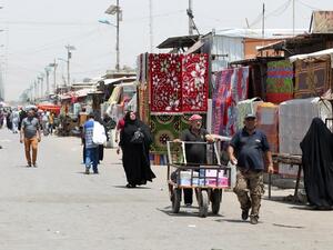Iraqi walk past stalls at Oraiba market on May 12, 2016, a day after it was struck by a car bomb attack in the frequently targeted Sadr City area of northern Baghdad. (AFP/Ahmad al-Rubaye)