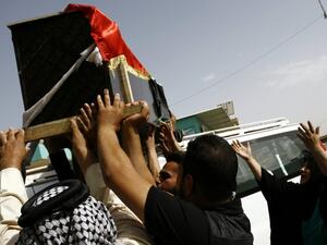 Iraqis carry the coffin of a victim of a car bombing in Baghdad's Shiite area of Sadr City during a funeral for people who died in the attack in the holy city of Najaf on May 11, 2016. (AFP/Haidar Hamdani)