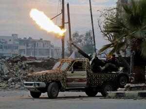 Fighters of the Free Syrian Army fire an anti-aircraft weapon in the rebel-held Mashhad area in southeastern Aleppo, on December 12, 2016. (AFP/File)