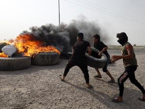 Iraqi protestors burn tyres during a gathering northwest of the southern city Basra on July 26, 2018, during a demonstration against unemployment and a lack of basic services.  (Haidar MOHAMMED ALI / AFP)