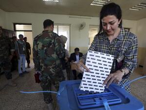 A member of the Kurdish security forces casts her ballot at a polling station for parliamentary election in Arbil, the capital of the Kurdish autonomous region in northern Iraq, on September 28, 2018, as Kurdish armed forces vote ahead of the general public. (SAFIN HAMED / AFP)