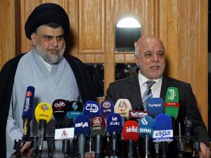 Iraqi Prime Minister Haider al-Abadi (R) and Shiite cleric leader Moqtada al-Sadr have reached an accord with 14 other Iraqi political grouping to form the biggest bloc in parliament. (AFP/ Haidar HAMDANI)