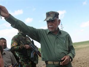 Iraqi commander of the Badr Organization, Hadi al-Ameri (R), standing in the Al-Alam area, north of Baghdad. (AFP/ Photo)