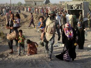 A displaced Iraqi family arrives at a safe zone on June 17, 2016 in Amiriyiah al-Fallujah, after Iraqi government forces evacuated civilians from Fallujah due to their ongoing military operation to retake the city from the Islamic State group. [AFP/Moadh Al-Dulaimi]
