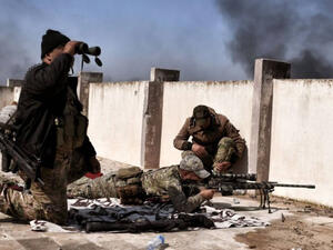 A sniper fires at targets during clashes with ISIS fighters in Mosul. (AFP/ File Photo)
