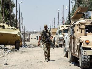 An Iraqi soldier walks down a street in Mosul's western Al-Shifa district on June 15, 2017, during the ongoing offensive by Iraqi forces to retake the city from Islamic State (IS) group fighters. (Mohamed El-Shahed/AFP)