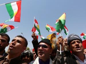 Iraqi Kurdish protesters wave flags of their autonomous Kurdistan region during a demonstration to claim for its independence. (AFP/Safin Hamed)