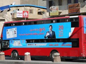 A bus displays poster advising people to check their voting information ahead of Iraq's parliamentary elections. (AFP/ File Photo)