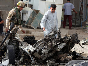 Iraqi troops inspect scene of car bomb in Baghdad. (AFP/Ahmed al-Rubaye)