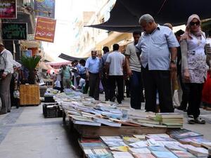 Pedestrians browse titles on al-Mutanabbi Street, Baghdad's famed cultural hub. (AFP/ File)