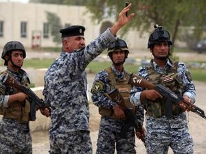 Iraqi policemen are seen on patrol inside a military base in Baghdad, on June 11, 2014, after the declaration of a state of emergency by the government. (AFP/Ahmad al-Rubaye)