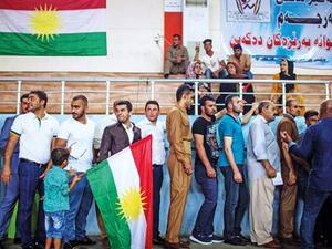 People queue to cast their votes on the Kurdish independence referendum at a stadium in Arbil yesterday. (AFP Photo)