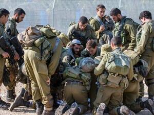 Israeli soldiers check a map as they patrol the northern Israeli-Lebanon border. (AFP/File)