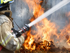 Firefighters spray water to wildfire. (Shutterstock/ File Photo)
