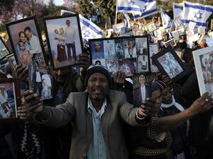 Ethiopian Israelis hold pictures of relatives as they protest in front of the Knesset in Jerusalem. (AFP/ File Photo)