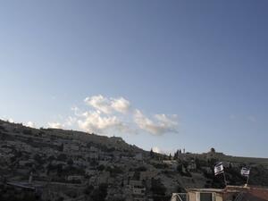 Israeli flags flying above the home of Palestinian family Abu Snineh, whose building was taken over by Jewish residents in the Silwan neighborhood of East Jerusalem, August 30, 2015. (AFP/Ahmad Gharabli)