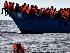 Migrants wait to be rescued as they drift in the Mediterranean Sea some 20 nautical miles north off the coast of Libya. (AFP/Aris Messinis)