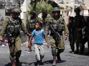 According to the PLO's Authority of Prisoners' Affairs, 1,266 Palestinian children below the age of 15, had spent time in Israeli detention in 2014. (AFP/File)