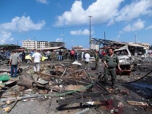 People gather at the site of one of the suicide bombings in Jableh, Syria on May 23. (AFP/File)