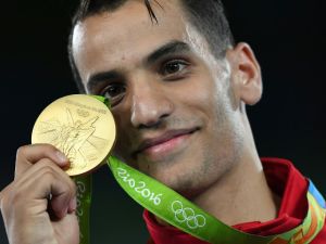 Jordan's Ahmad Abughaush poses with his gold medal on the podium after the men's taekwondo event in the -68kg category as part of the Rio 2016 Olympic Games, on August 18, 2016, at the Carioca Arena 3, in Rio de Janeiro. (AFP/Kirill Kudryavtsev)