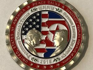 A commemorative coin for the upcoming U.S. and North Korean meeting is seen at White House, (AFP/File Photo)