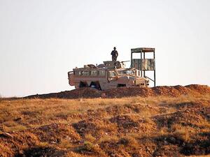 A Jordanian soldier keeps watch at the border between Syria and Jordan on Monday (AFP photo)