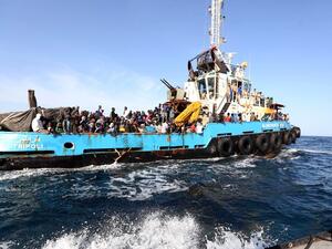 A Libyan coastguard boat carrying migrants near the port of Misrata. (AFP/Mahmud Turkia)