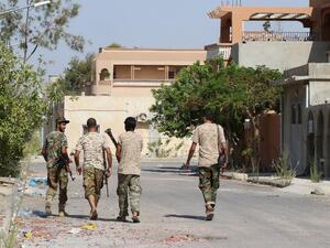Fighters from the pro-government forces loyal to Libya's Government of National Unity (GNA) walk on August 3, 2016 in Sirte during an operation against Daesh. (AFP/Mahmud Turkia)