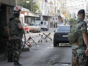 Members of Lebanese General Security observe passing cars at a checkpoint. (AFP/File)