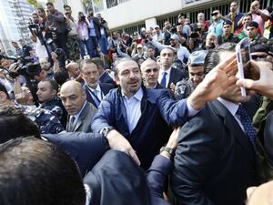 Former Lebanese Prime Minister Hariri takes a selfie with voters outside of a polling station. (AFP/Anwar Amro)