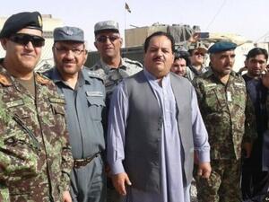 Helmand's security chief Abdul Jabar Qahraman (C) surrounded by police and army officers. (Social Media)