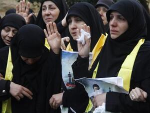 Mourners gesture during the funeral of Mohammed Hijazi, a member of Lebanon's Hezbollah movement who was killed in combat alongside Syrian government forces in Syria, on February 1, 2016, in the Lebanese capital Beirut. (AFP/Stringer)