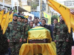 Adnan (C-L) and Hassan Badreddine (C-R), brothers of slain top Hezbollah commander Mustafa Badreddine who was killed in an attack in Syria, mourn next to his casket during the funeral in the Ghobeiry neighborhood of southern Beirut on May 13, 2016. (AFP/Anwar Amro)