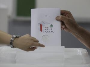 A Lebanese man puts his checked ballot in the box as he casts his vote in the first parliamentary election in nine years. (AFP/ File Photo)