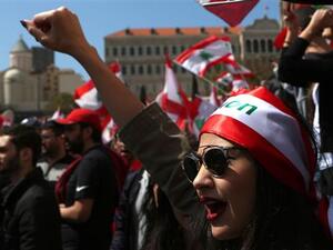 A Lebanese woman raises her fist as she shouts slogans during a protest in downtown Beirut. (AFP/ File Photo)