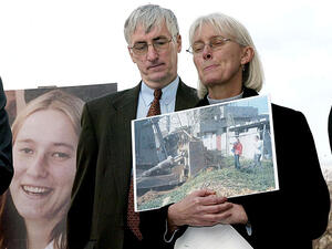 Craig and Cynthia Corrie speak about their daughter Rachel, shown on a poster, at a press conference on Capitol Hill/ AFP