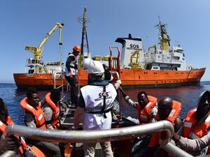 Migrants and refugees are seen during a rescue operation at sea of the Aquarius, a ship now used by humanitarians SOS Mediterranee and Medecins Sans Frontieres, on May 24, 2016 off the Libyan coast. (AFP/Gabriel Bouys)