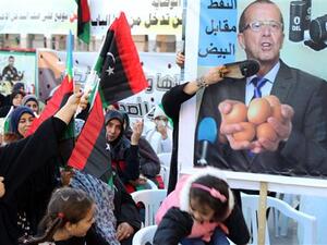 Women place a shoe on a placard bearing a portrait of UN Special Envoy for Libya Martin Kobler during a demonstration against a UN-sponsored agreement on forming a national unity government in the capital, Tripoli, January 8, 2016. (AFP/File)