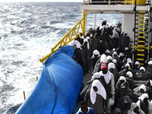 Migrants protect themselves from the cold with blankets as they wait to arrive in the port of Cagliari, Sardinia, on May 26, 2016 aboard the rescue ship "Aquarius", two day after their rescue off the Libyan coasts. (AFP/Gabriel Bouys)