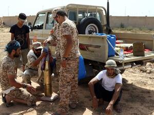 Fighters from forces loyal to Libya's Unity Government gather next to a pick up truck on July 2, 2016 as they take position to hit Daesh targets in Sirte during an operation to recapture the coastal city. (AFP/Mahmud Turkia)
