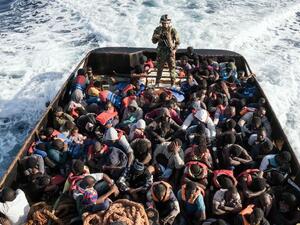 A Libyan coast guardsman stands on a boat during the rescue of 147 illegal immigrants attempting to reach Europe off the coastal town of Zawiyah. (AFP/ File Photo)