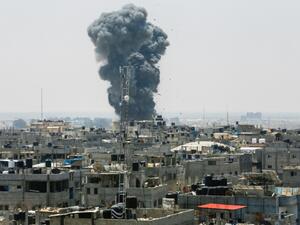 A heavy smoke cloud rises following an Israeli air strike in the southern Gaza Strip city of Rafah on July 14. (AFP)
