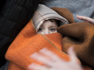 A refugee child wrapped in a blanket (Shutterstock/File Photo)