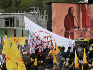 Supporters listen to Maryam Radjavi (on screen), president of the NCRI and Mujahedeen-e-Khalq (MEK) leader (AFP)